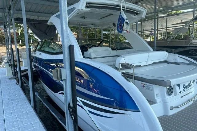 Slide: The Image of 2023 Formula 350 Crossover Bowrider I/O docked, showcasing sleek design and spacious seating. - 2