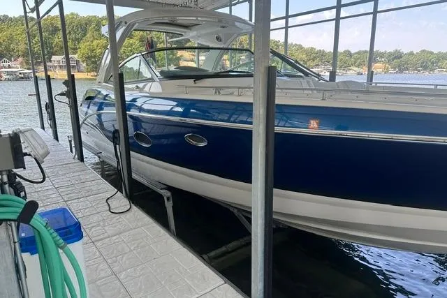 Slide: The Image of 2023 Formula 350 Crossover Bowrider I/O docked, featuring sleek blue and white design. - 8
