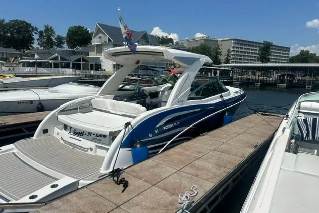 Slide: The Image of 2023 Formula 350 Crossover Bowrider I/O docked at marina under clear sky. - 9