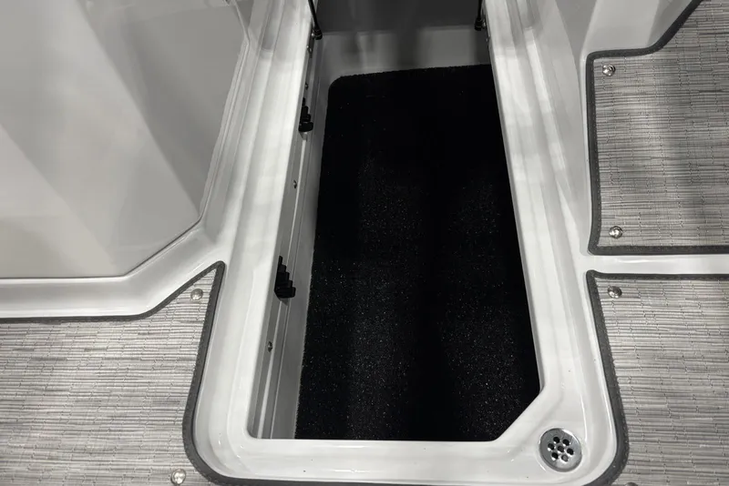 Slide: The Image of 2026 Cobalt R6 boat storage compartment with textured flooring and drainage. - 18