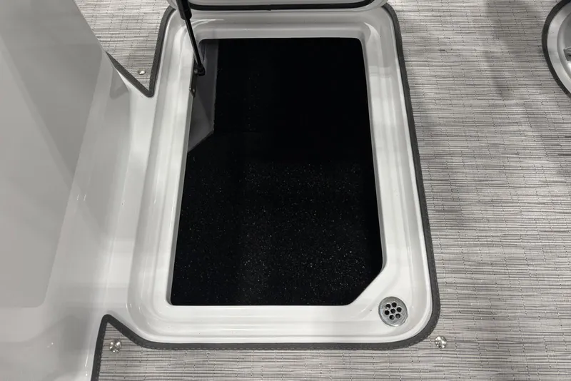 Slide: The Image of Open storage compartment on 2026 Cobalt R6 boat with textured flooring. - 20