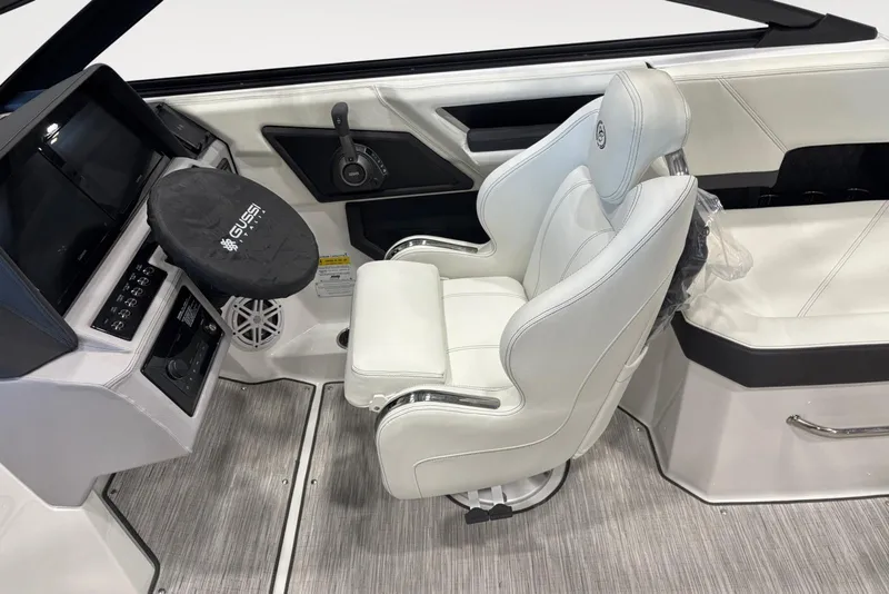 Slide: The Image of 2026 Cobalt R6 boat interior with white captain's chair and control panel. - 9