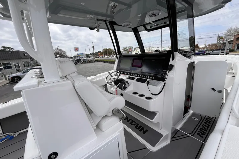 Slide: The Image of 2026 Fountain 38 Tournament Edition boat cockpit with advanced navigation system and sleek white seating. - 11