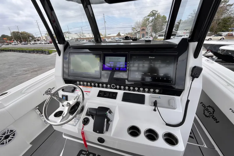 Slide: The Image of 2026 Fountain 38 Tournament Edition boat dashboard with advanced navigation displays and controls. - 12