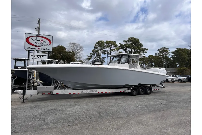 Slide: The Image of 2026 Fountain 38 Tournament Edition boat on trailer at Marker 17 Marine dealership. - 2