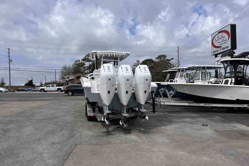 Slide: The Image of 2026 Fountain 38 Tournament Edition boat with triple engines at a marine dealership. - 4