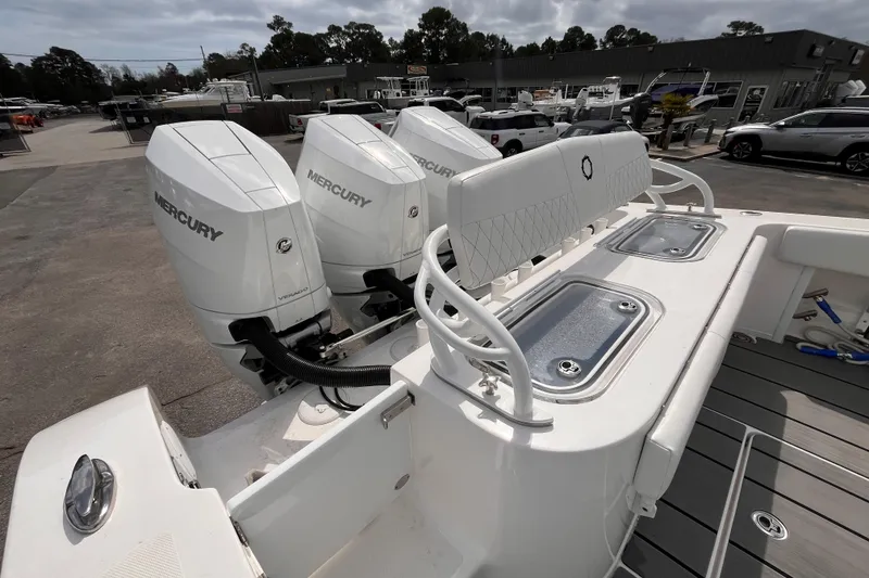 Slide: The Image of 2026 Fountain 38 Tournament Edition boat with triple Mercury engines at a marina. - 6