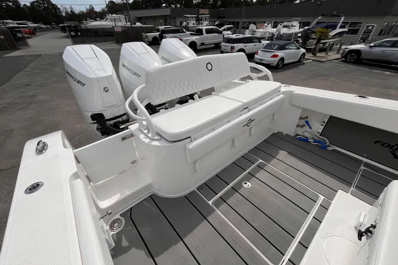 Slide: The Image of 2026 Fountain 38 Tournament Edition boat with triple Mercury engines, docked in a marina. - 7