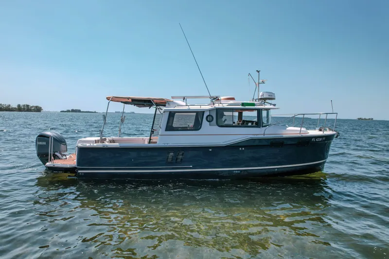 The Image of 2024 FML R27 LE boat on calm water, featuring a sleek design and Yamaha engine. - 0