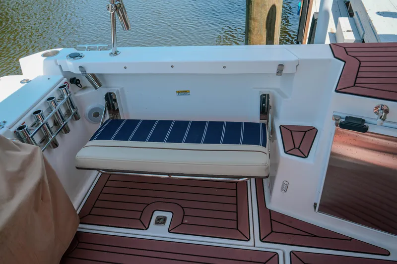 Slide: The Image of 2024 FML R27 LE boat interior with striped seating and rod holders. - 12