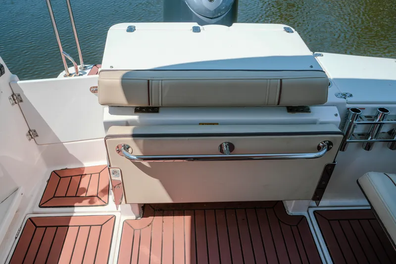 Slide: The Image of 2024 FML R27 LE boat interior with cushioned seating and wooden flooring. - 14