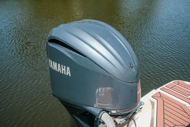 Slide: The Image of Yamaha outboard motor on a boat, model FML R27 LE, 2024, on calm water. - 16