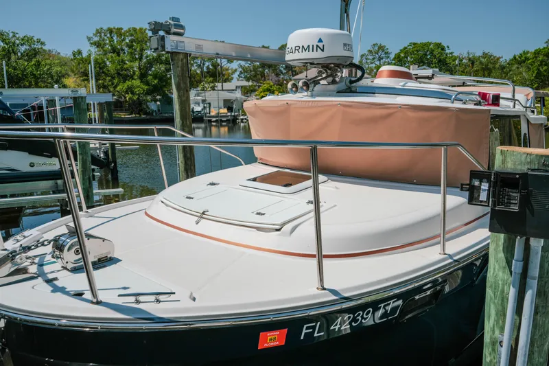 Slide: The Image of 2024 FML R27 LE boat docked with Garmin radar, sunny day. - 18