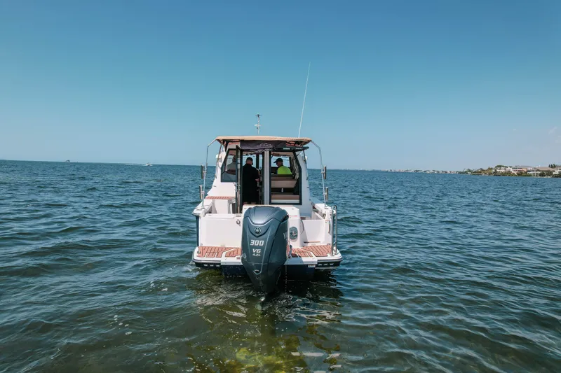 Slide: The Image of 2024 FML R27 LE boat cruising on open water with clear blue sky. - 22