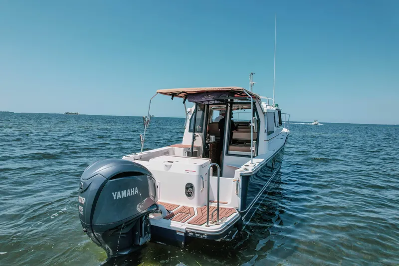 Slide: The Image of 2024 FML R27 LE boat with Yamaha engine on open water. - 23