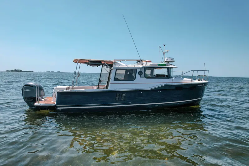 Slide: The Image of 2024 FML R27 LE boat on calm water, featuring Yamaha outboard motor. - 27