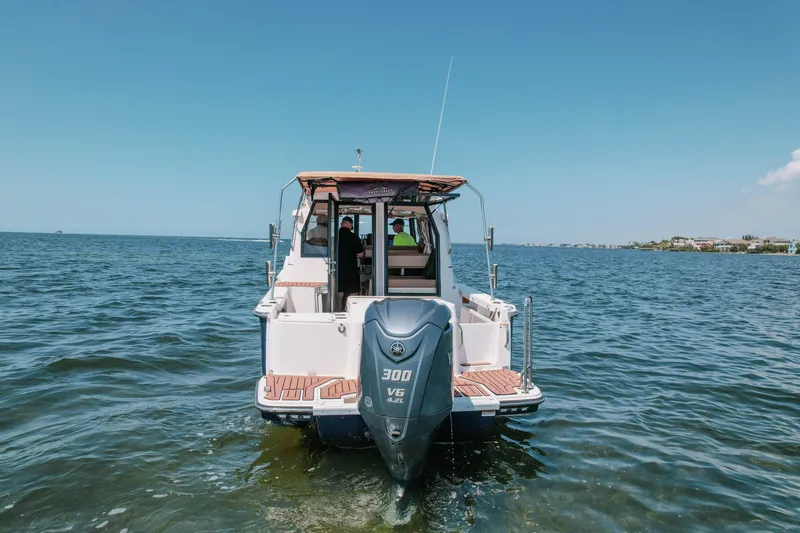 Slide: The Image of 2024 FML R27 LE boat with 300 V6 engine on open water. - 3