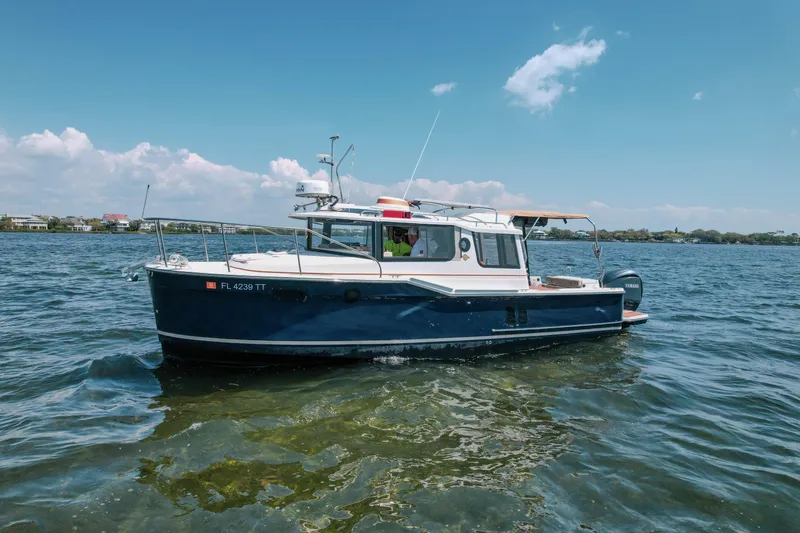 Slide: The Image of 2024 FML R27 LE boat cruising on a sunny day in open water. - 30