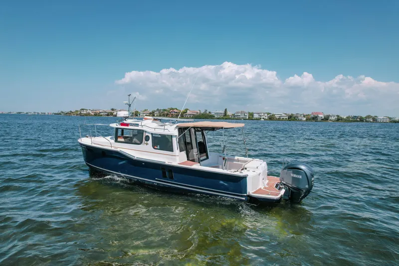 Slide: The Image of 2024 FML R27 LE boat cruising on a sunny day in calm waters. - 31