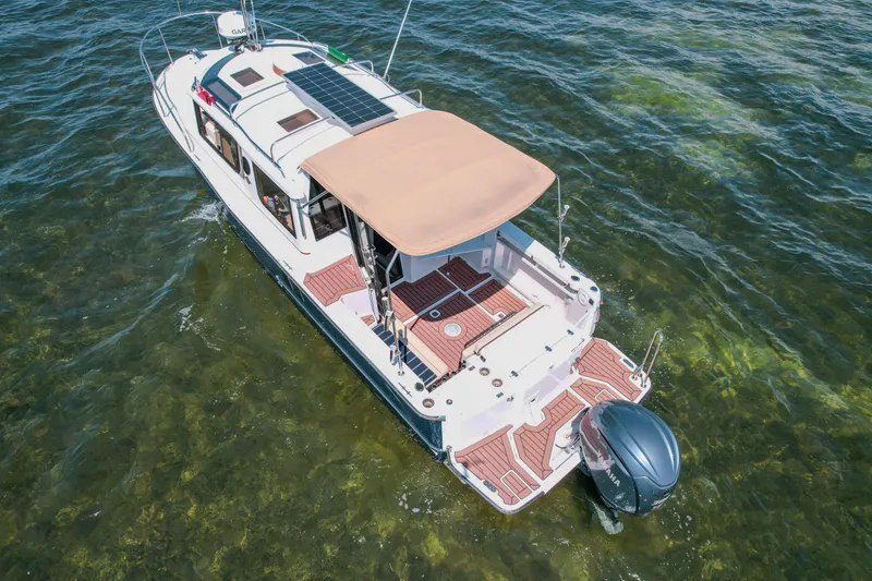 Slide: The Image of 2024 FML R27 LE boat with solar panels on calm water. - 32