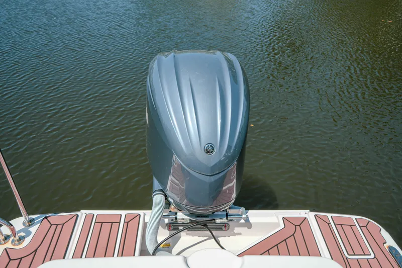Slide: The Image of 2024 FML R27 LE boat with outboard motor on calm water. - 35