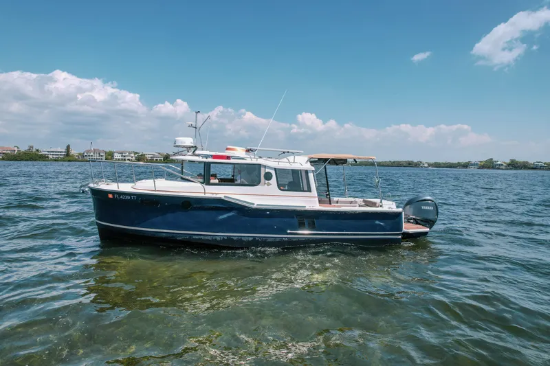 Slide: The Image of 2024 FML R27 LE boat on calm water under a clear blue sky. - 4