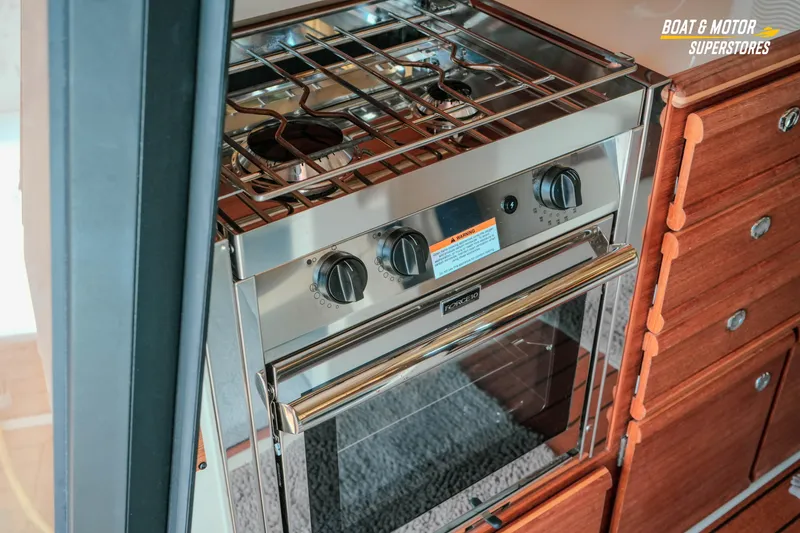 Slide: The Image of 2024 Ranger Tugs R-27 interior kitchen with stainless steel stove and oven. - 44