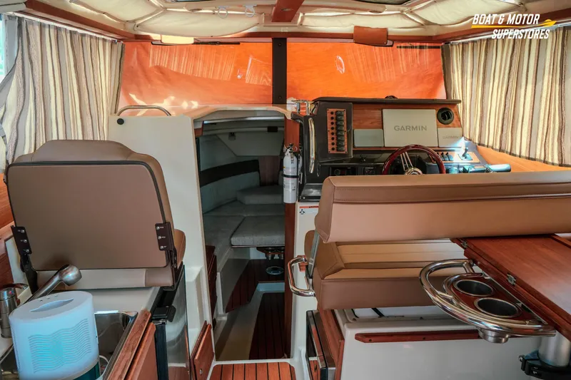 Slide: The Image of Interior of 2024 Ranger Tugs R-27 boat with Garmin navigation system and cozy seating. - 45