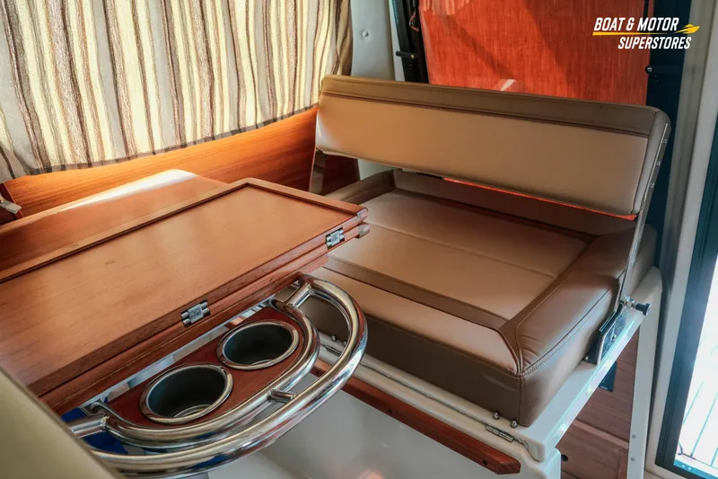 Slide: The Image of 2024 Ranger Tugs R-27 interior with foldable table and cup holders. - 51