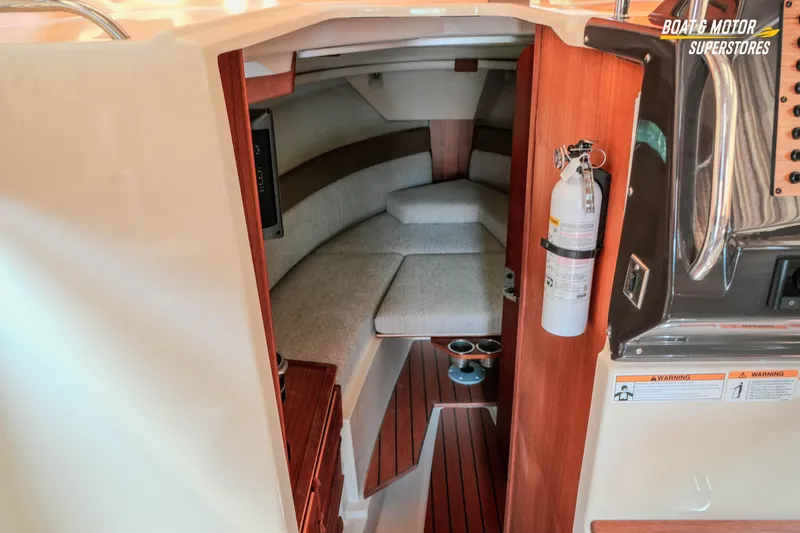 Slide: The Image of 2024 Ranger Tugs R-27 cabin interior with seating and safety equipment. - 54