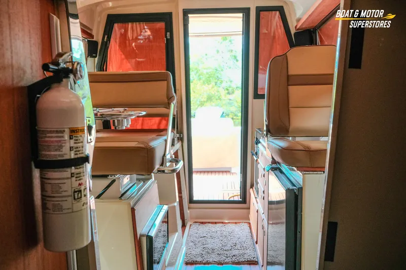 Slide: The Image of Interior of 2024 Ranger Tugs R-27 boat with seating and fire extinguisher. - 57