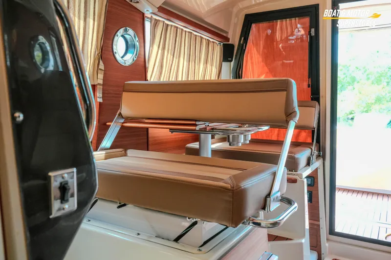 Slide: The Image of Interior of 2024 Ranger Tugs R-27, featuring stylish seating and elegant wood finishes. - 58