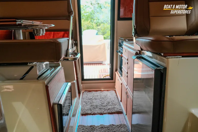 Slide: The Image of Interior of 2024 Ranger Tugs R-27 boat, featuring seating and kitchenette area. - 59