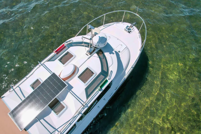 Slide: The Image of 2024 FML R27 LE boat with solar panels on clear water. - 6