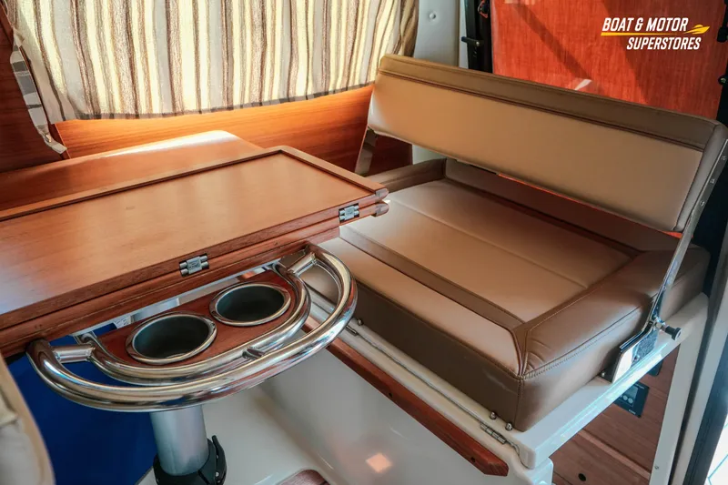 Slide: The Image of 2024 Ranger Tugs R-27 interior with foldable table and cushioned seating. - 62