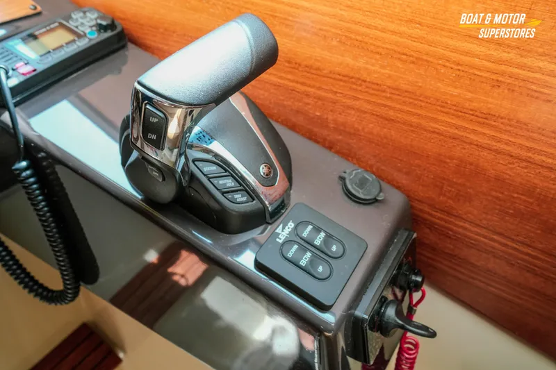 Slide: The Image of 2024 Ranger Tugs R-27 boat throttle control and navigation equipment. - 69