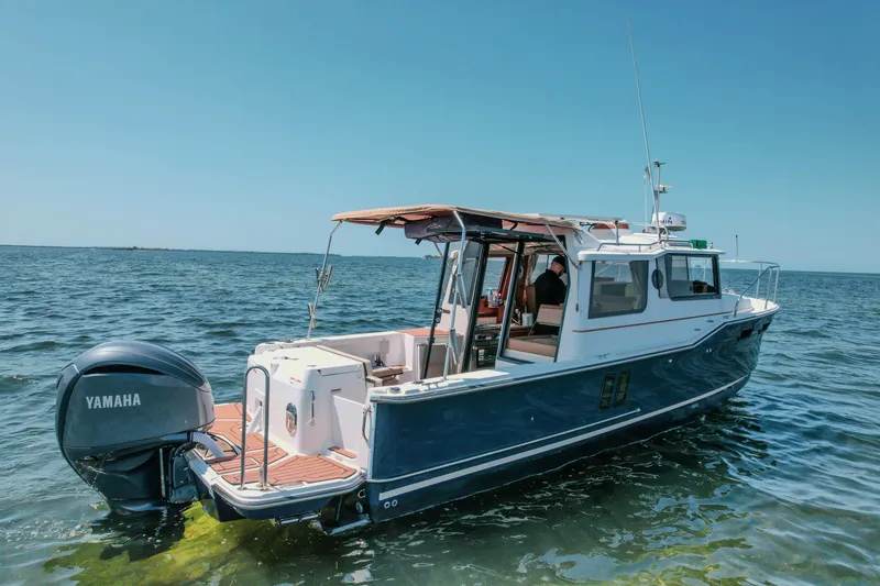 Slide: The Image of 2024 FML R27 LE boat with Yamaha engine on open water. - 8