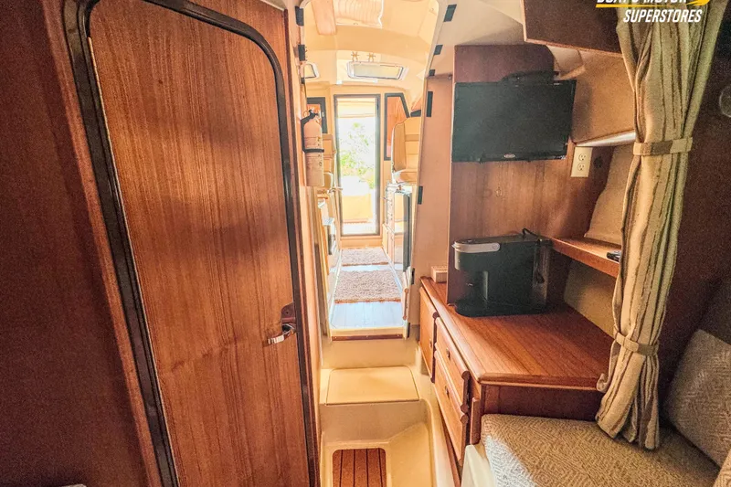 Slide: The Image of Interior of 2024 Ranger Tugs R-27 boat, featuring wood finishes and compact design. - 80