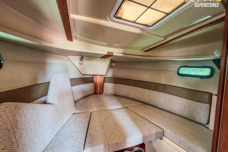 Slide: The Image of 2024 Ranger Tugs R-27 cabin interior with cozy seating and natural light. - 82