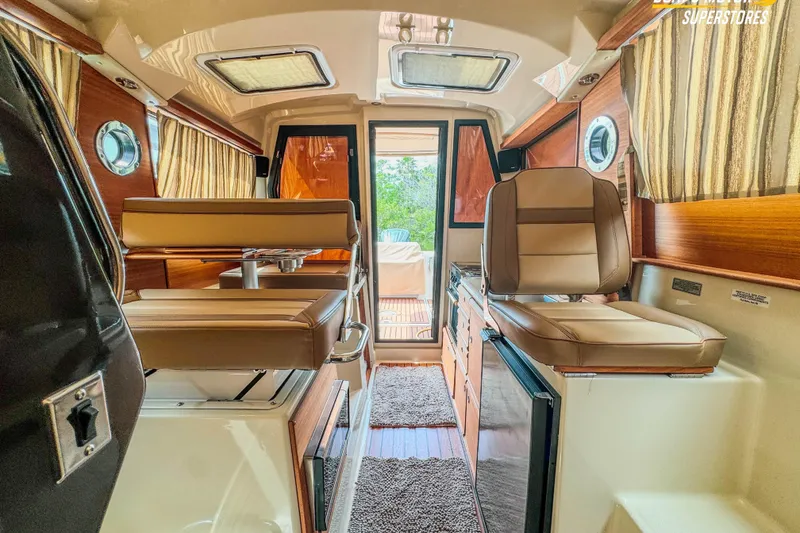 Slide: The Image of 2024 Ranger Tugs R-27 interior with leather seating and wood accents. - 83