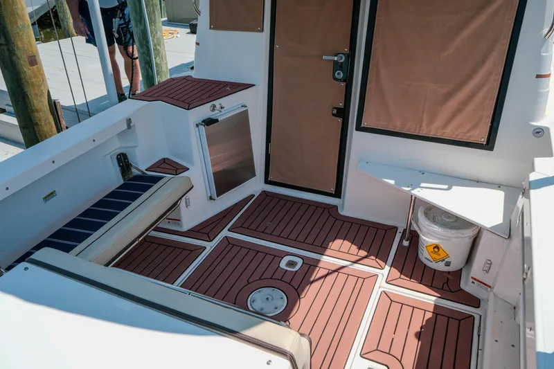 Slide: The Image of 2024 FML R27 LE boat interior with wood flooring and seating area. - 9