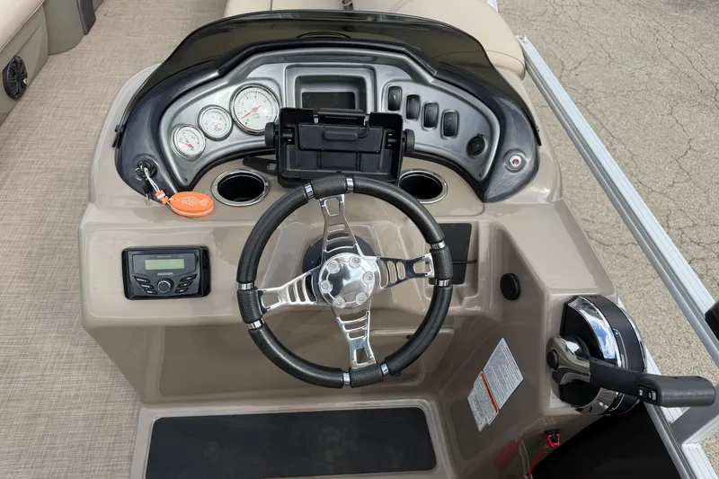 Slide: The Image of 2022 Sun Tracker Party Barge 20 DLX dashboard with steering wheel and controls. - 11