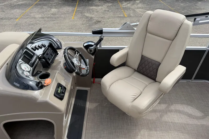 Slide: The Image of 2022 Sun Tracker Party Barge 20 DLX helm with beige captain's chair and control panel. - 15