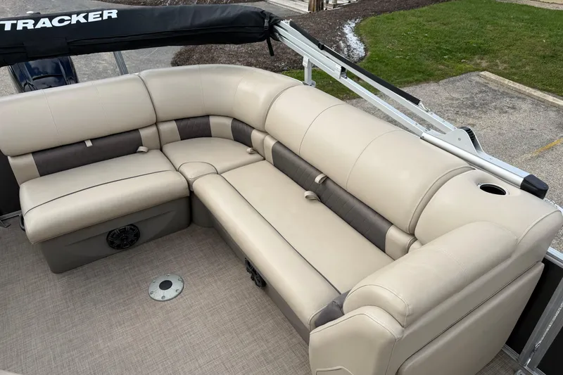Slide: The Image of 2022 Sun Tracker Party Barge 20 DLX with beige seating and cup holder. - 16