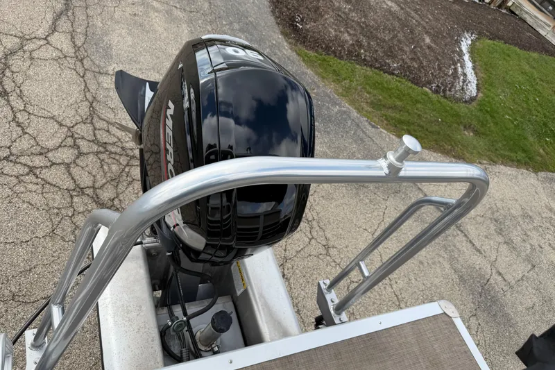 Slide: The Image of 2022 Sun Tracker Party Barge 20 DLX with Mercury outboard motor on a paved surface. - 17