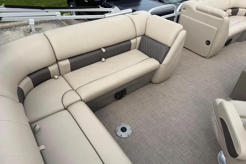 Slide: The Image of 2022 Sun Tracker Party Barge 20 DLX interior with beige seating and spacious layout. - 2