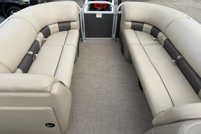 Slide: The Image of 2022 Sun Tracker Party Barge 20 DLX interior with beige seating and spacious layout. - 6