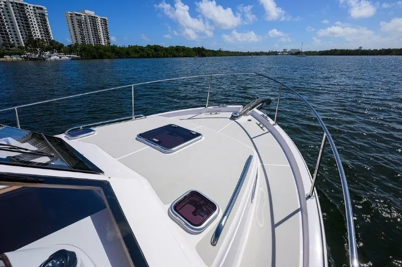 Slide: The Image of 2022 True North 34 yacht cruising on a sunny day with cityscape in background. - 43