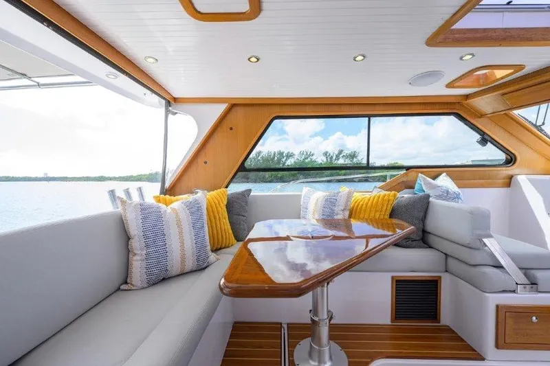 Slide: The Image of Luxurious interior of 2022 True North 34 yacht with plush seating and scenic window view. - 49