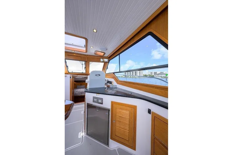 Slide: The Image of Interior of 2022 True North 34 yacht with wood accents and waterfront view. - 53